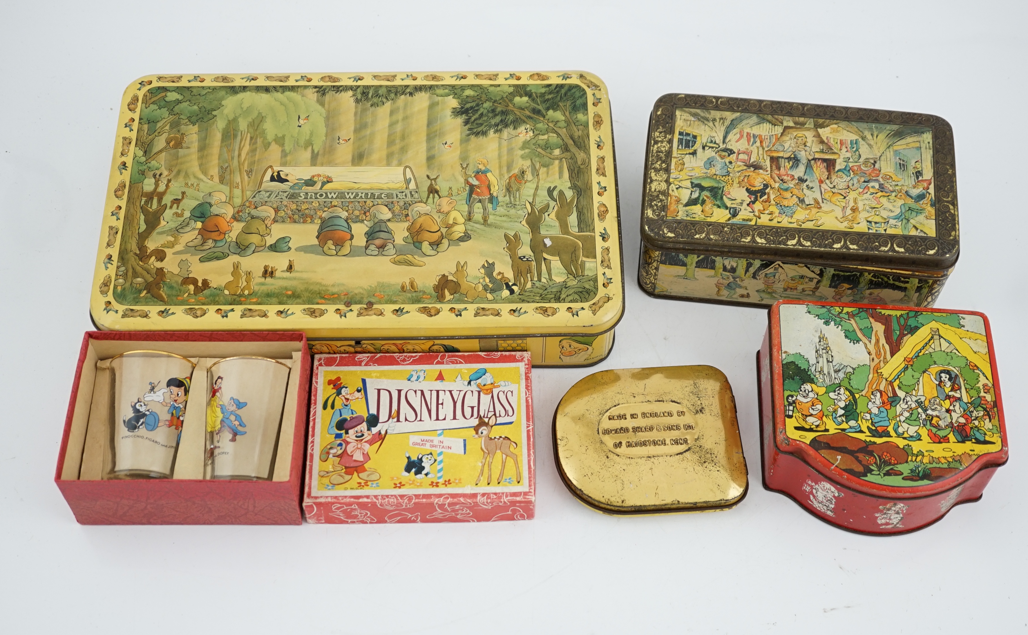 A collection of Disney Snow White memorabilia, including a porcelain set of eight figures by Goebel, W. Germany